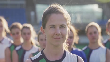 female hockey players smiling and looking at camera