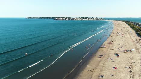 people sunbathing and swimming at the beach in nahant, massachusetts, usa. - aerial shot