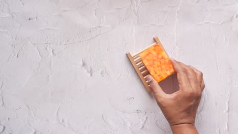 handmade orange soap in wooden dish