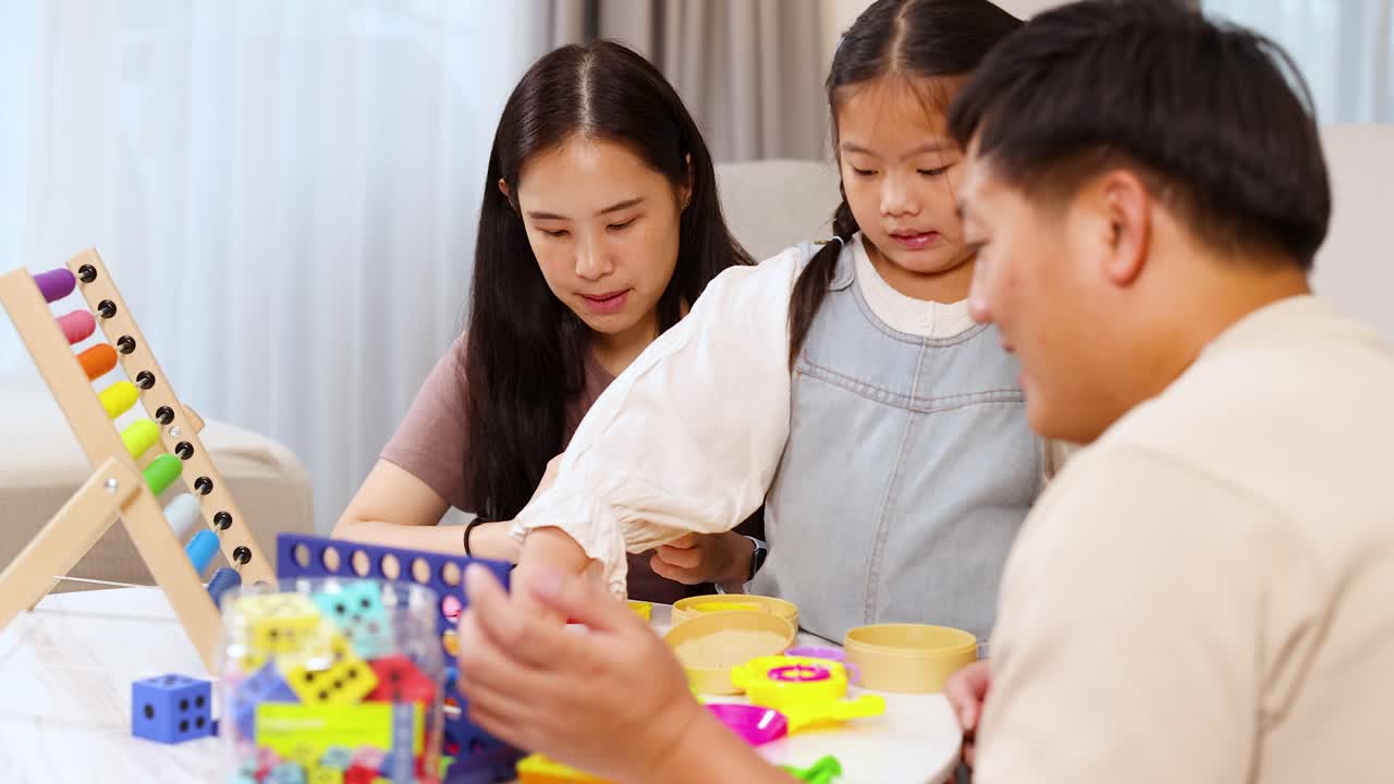 Parents and daughter interact with colorful educational toys in a bright, cozy living room setting