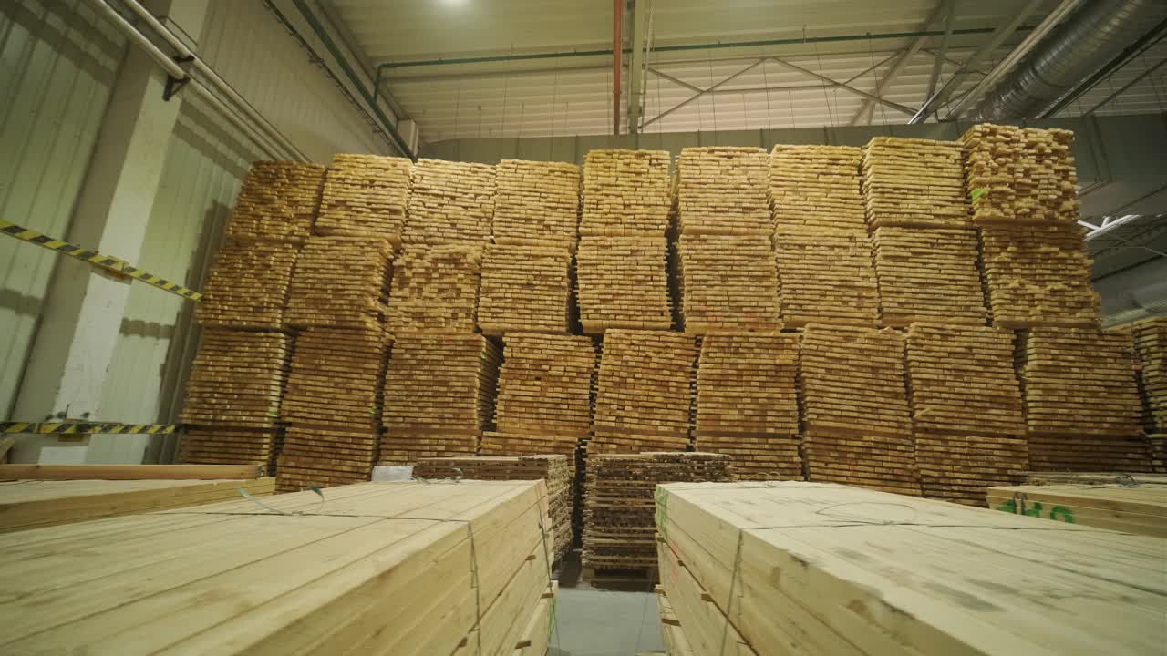Large Stacks of Wooden Planks Stored in an Industrial Warehouse