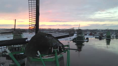 Flying-past-Dutch-Windmill-with-magical-sunrise,-The-Young-Sheep-sawmill