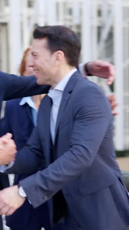 businessmen joyfully greeting and socializing