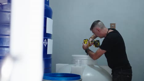 man drilling a water tank