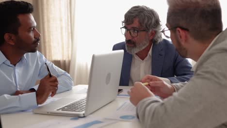 multi-ethnic and generational business people working together inside bank office