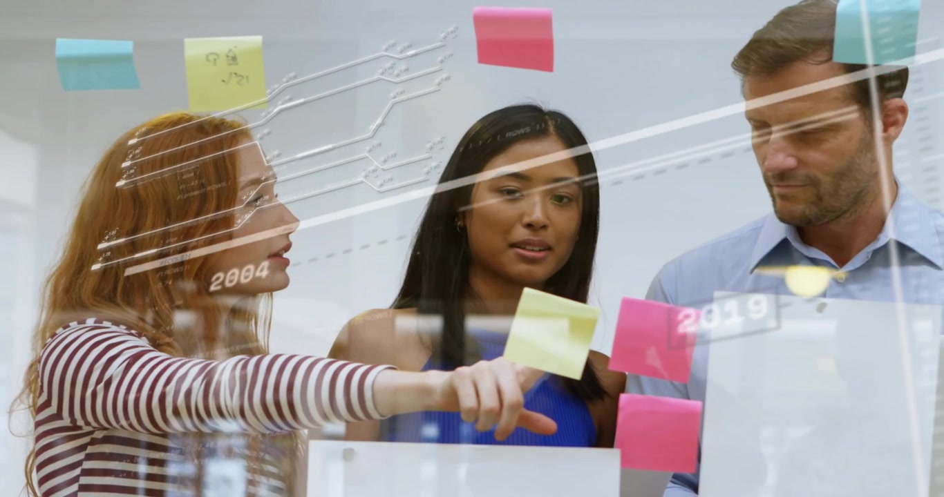 Redheaded woman pointing note causing business timeline update moving sticky notes on glass board