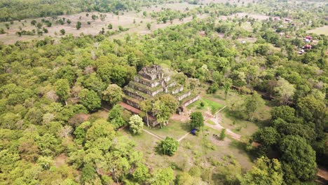 angkor temple aerial, prang - the koh ker pyramid temple, nested in the mystic cambodian jungle, drone rotation 4k footage