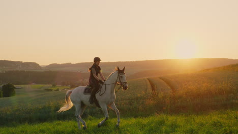 a woman gallops on a white horse in the sunrise