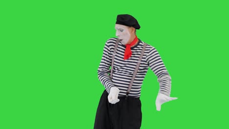 mime pulling an imaginary rope on a green screen, chroma key