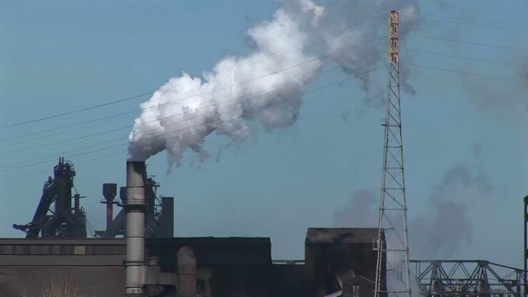 Smoke Billows Out Of An Industrial Building'S Smokestack