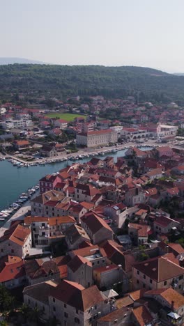 Drone capturing the picturesque town of Stari Grad on Hvar Island, Croatia, showcasing its charming harbor, traditional architecture, and surrounding landscape
