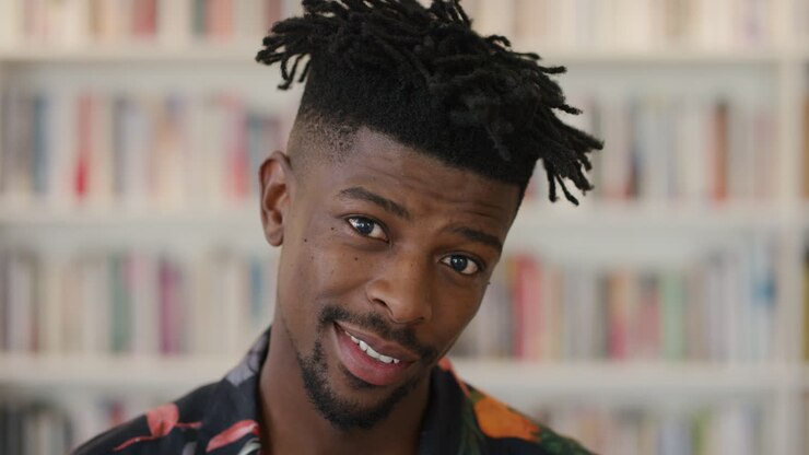 close up attractive african american man student smiling confident successful black male funky hairstyle looking happy expression
