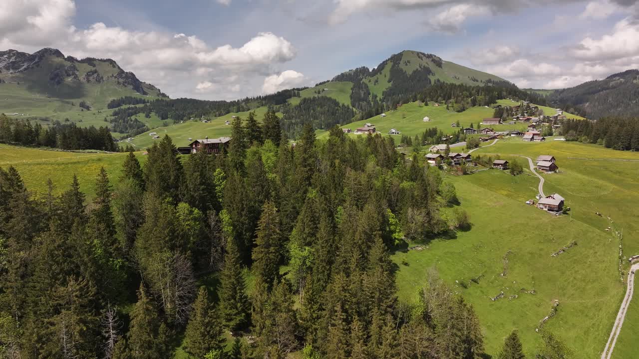 Scenic aerial shot of forested hills, Swiss mountain landscapes in Amden area
