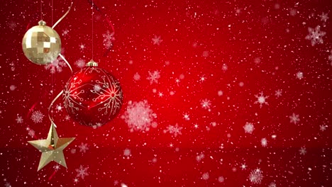 Animation-of-snow-falling-over-red-and-gold-christmas-baubles-decoration