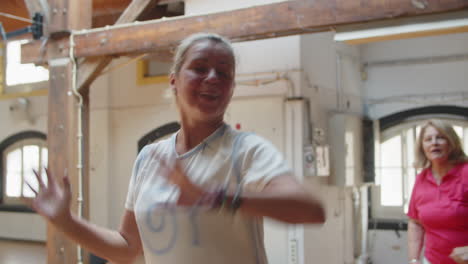 Tracking-shot-of-hard-breathing-woman-dancing-in-studio