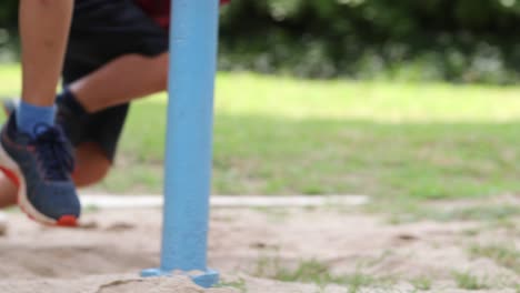 kid falling to the ground while playing with carousel spinning