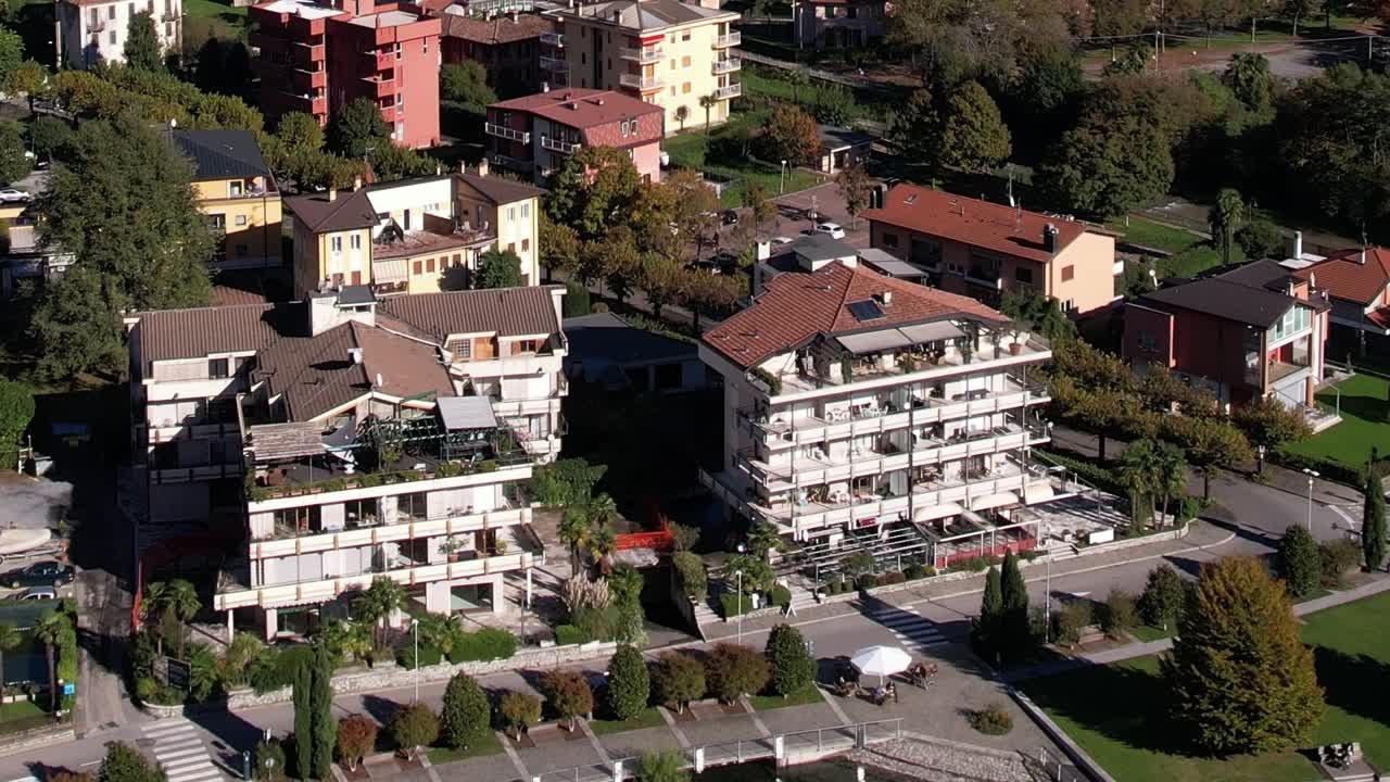 Scenic drone view of lakeside buildings in the Italian Alps