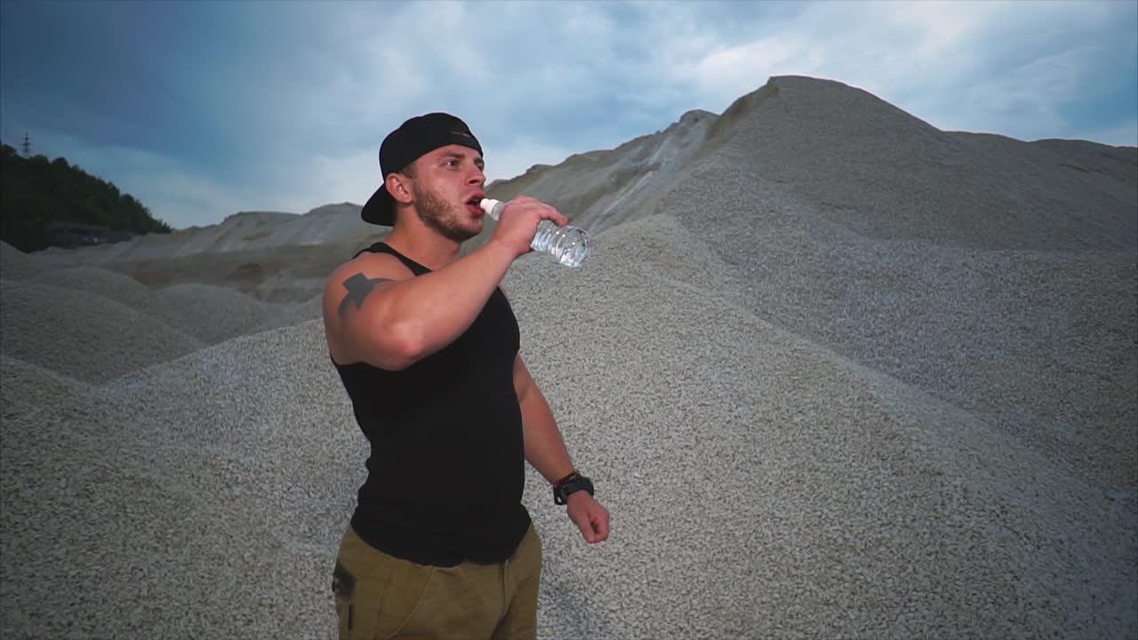 Man Drinking Water in a Quarry