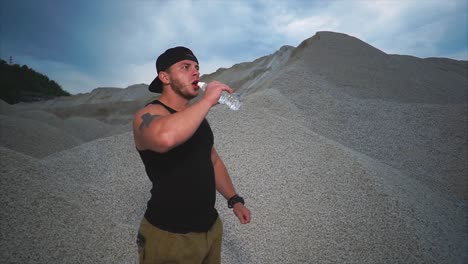 man drinking water in a quarry