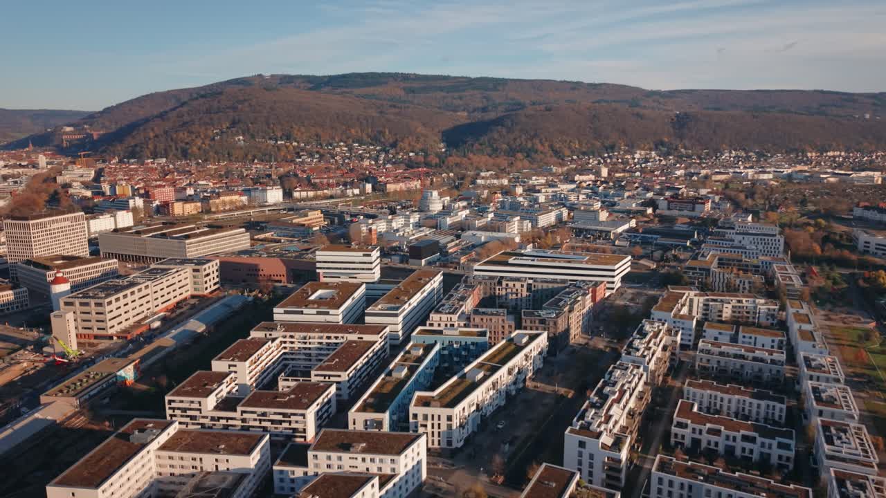 Urban Transition: Aerial View Contrasting Heidelberg's Modern Passive House District with the Historic Cityscape and Hilly Surroundings