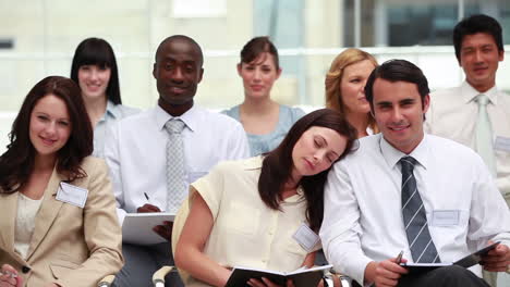 Man-smiling-while-a-woman-is-sleeping-on-his-shoulder