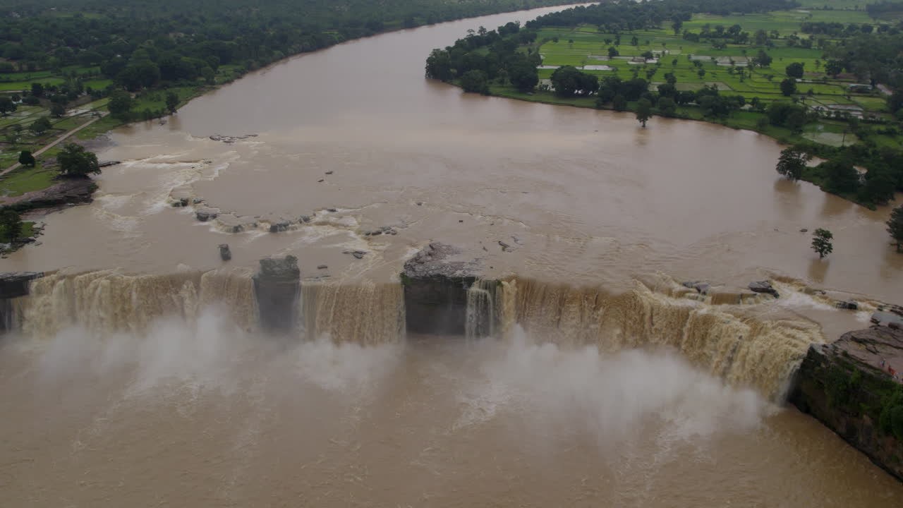 Cinematic aerial track-out shot of a beautifull waterfall