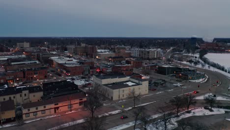 Aerial,-downtown-Stevens-Point,-Wisconsin,-in-the-evening-during-winter-season