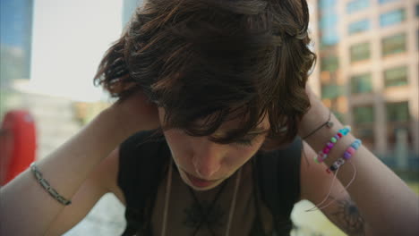 outdoor fashion portrait of young alternative style woman with tattoos and piercing at canary wharf in london docklands shot in real time 3