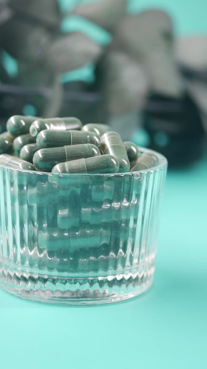Close-Up of Green Capsules in a Glass Bowl