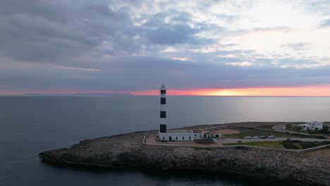 aerial zoom outs summer evening skyline over menorca lighthouse tower, spanish travel destination