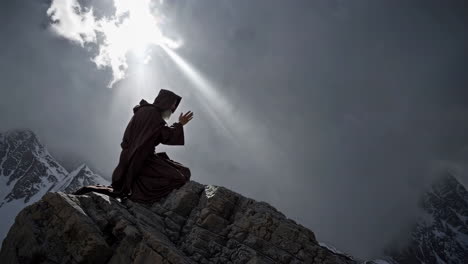 monk praying on a mountaintop