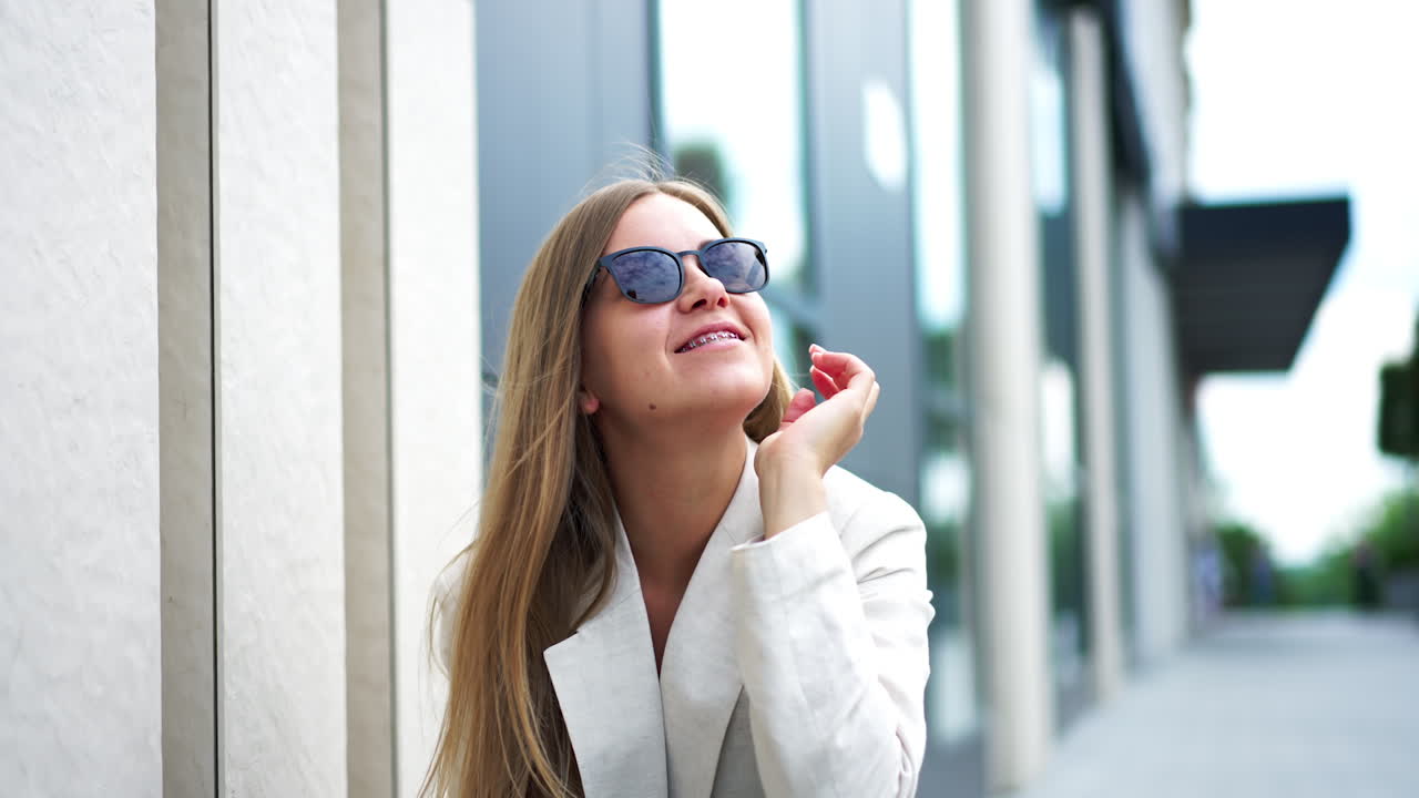 Woman in a Beige Jacket and Sunglasses