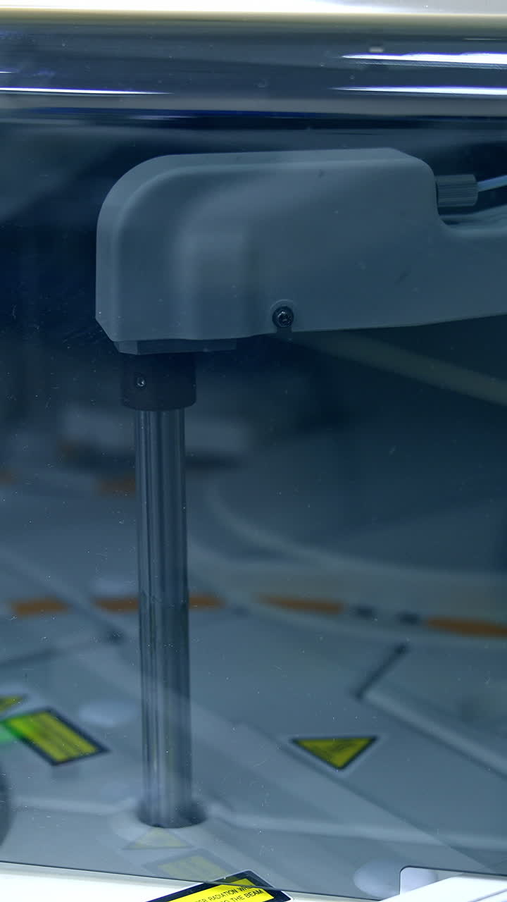 Moving details inside the technological machine. Advanced equipment in modern laboratory for medical tests. Close up. Vertical video