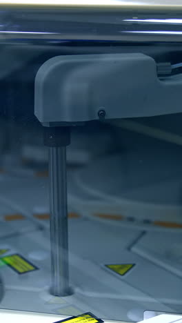 moving details inside the technological machine. advanced equipment in modern laboratory for medical tests. close up. vertical video