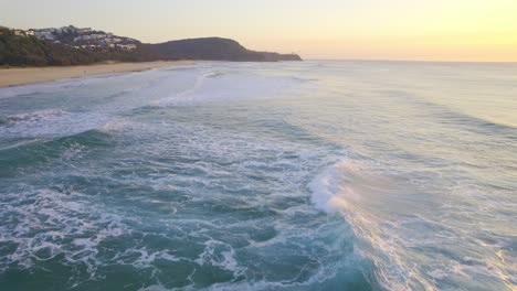 ocean waves in sunshine beach during sunrise - surfing spot in noosa, qld, australia
