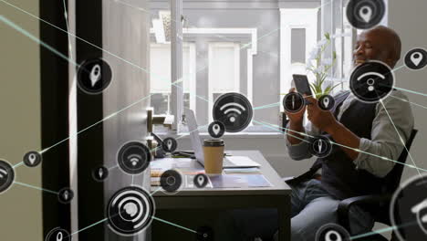 Using-smartphone-at-desk,-man-surrounded-by-network-connectivity-animation