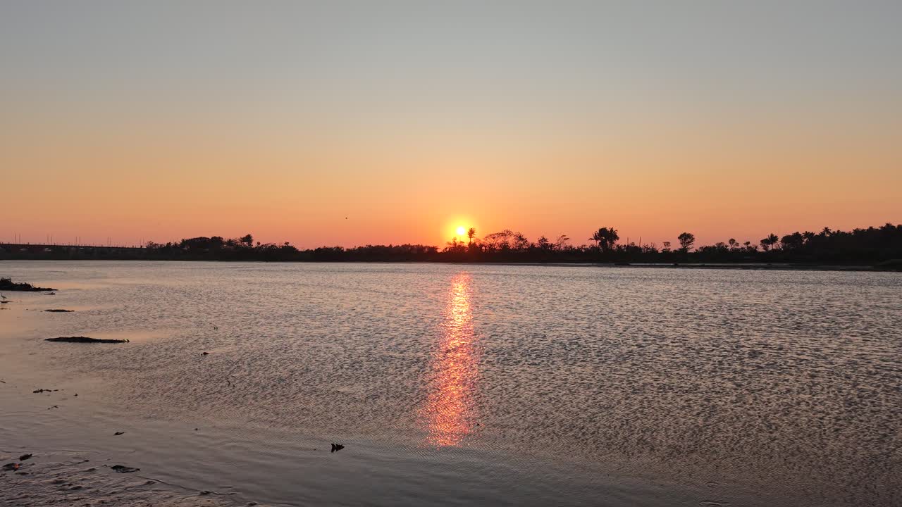 A beautiful sunset silhouetted against a swamp, river, and trees. This video is perfect for an intro or opening