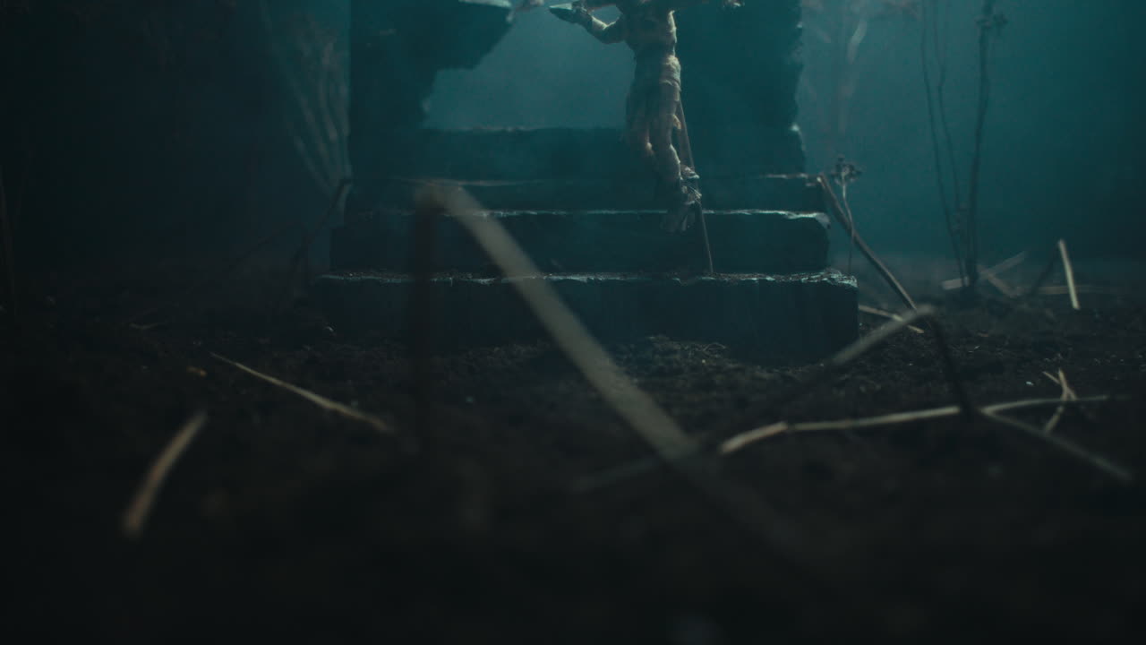 A miniature scene of the mummified dolls hanging on the gallows at night