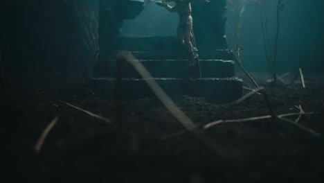a miniature scene of the mummified dolls hanging on the gallows at night