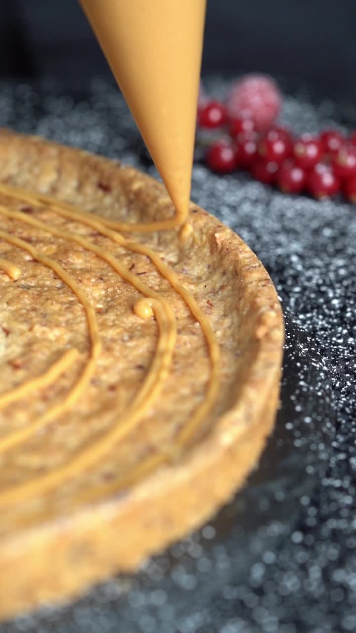 A skilled chef adding smooth caramel sauce to a delicious cake, close up shot, insert shot