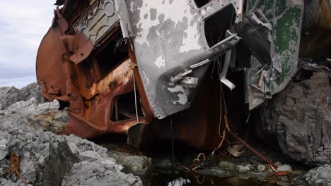 rusty shipwreck on the rocky beach