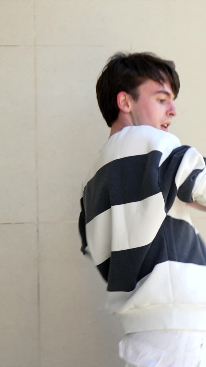 A person is standing in front of a wall