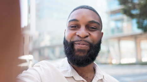 man holding camera phone speaking happily