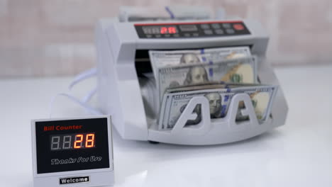 automatic calculation. electronic counter machine on the table. small bill counter device showing the amount of counting paper money. financial operations in bank.
