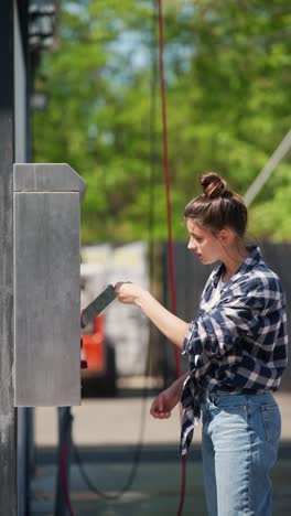 woman paying for self-service car wash