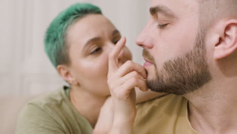 close up of a loving couple cuddling and kissing in the bedroom