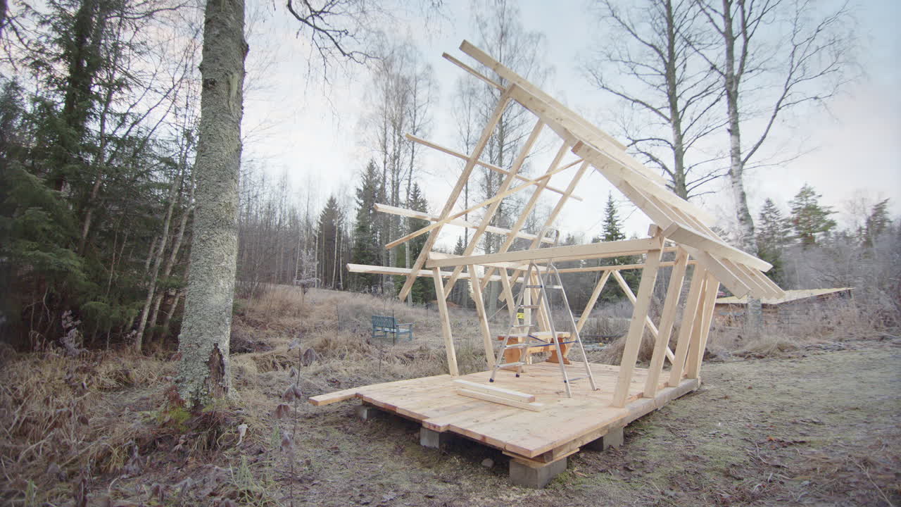Timber structure of unfinished off grid tiny house project in woods, slider