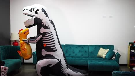 halloween dinosaur costume with man in the living room of the house with a little dinosaur