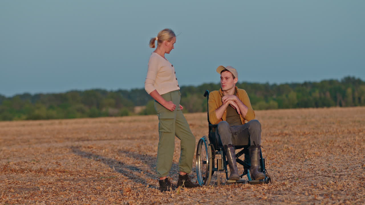 una pareja en un campo al atardecer.