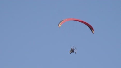 isolated shot of a solo paraglider, paragliding is a solo extreme sport